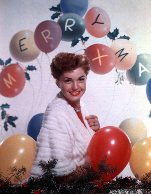Circa 1950's American actress Esther Williams with balloons at Christmas time.